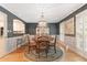 Elegant dining room features a chandelier, hardwood floors and french doors for natural light at 960 Lost Forest Dr, Sandy Springs, GA 30328