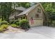 Spacious home features a two-car garage with a basketball hoop and an American flag at 960 Lost Forest Dr, Sandy Springs, GA 30328