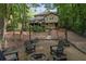 Backyard fire pit area with outdoor seating and string lights for evening gatherings at 960 Lost Forest Dr, Sandy Springs, GA 30328