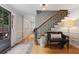 Inviting foyer featuring hardwood floors, staircase with iron railings, and bench seating at 960 Lost Forest Dr, Sandy Springs, GA 30328
