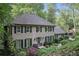Charming brick home featuring mature landscaping, black shutters and a welcoming front entrance at 960 Lost Forest Dr, Sandy Springs, GA 30328