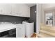 Well-equipped laundry room with ample storage, a utility sink, and modern washer and dryer units at 960 Lost Forest Dr, Sandy Springs, GA 30328