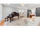 Comfortable living room with hardwood floors and a grand piano with lots of seating at 960 Lost Forest Dr, Sandy Springs, GA 30328