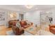 Cozy living room featuring a stylish leather sofa, hardwood floors, and decorative accents at 960 Lost Forest Dr, Sandy Springs, GA 30328
