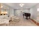 Comfortable living room with hardwood floors and a grand piano near lots of seating at 960 Lost Forest Dr, Sandy Springs, GA 30328