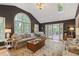 Light-filled living room with vaulted ceiling, large windows, and access to the outdoor deck at 960 Lost Forest Dr, Sandy Springs, GA 30328