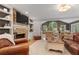 Cozy living room with stone fireplace, custom built-ins, and hardwood floors at 960 Lost Forest Dr, Sandy Springs, GA 30328