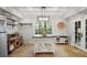 Mudroom features travertine floors, serving area, bar, and glass doors to the outside at 960 Lost Forest Dr, Sandy Springs, GA 30328