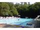 Community swimming pool with lounge chairs and a diving board on a sunny day at 960 Lost Forest Dr, Sandy Springs, GA 30328