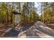 Community walking path with a sign for the Lost Corner Preserve in a wooded area at 960 Lost Forest Dr, Sandy Springs, GA 30328
