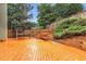 Large deck with built-in seating and a pergola, surrounded by privacy fence and landscaping at 947 Summer Forest Drive, Suwanee, GA 30024