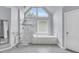 Bathroom featuring a glass shower, soaking tub, and large windows at 947 Summer Forest Drive, Suwanee, GA 30024