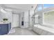 Bathroom with a glass shower, soaking tub, and marble tile at 947 Summer Forest Drive, Suwanee, GA 30024