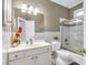 Bright bathroom featuring a white vanity, tiled walls, and a shower/tub combo at 947 Summer Forest Drive, Suwanee, GA 30024