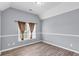 Bedroom with wood-look floors, and lots of light from the window at 947 Summer Forest Drive, Suwanee, GA 30024