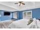 Bright bedroom with a ceiling fan and two windows providing plenty of natural light at 947 Summer Forest Drive, Suwanee, GA 30024