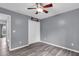 Bedroom with gray walls, wood-look flooring, a ceiling fan and a closet at 947 Summer Forest Drive, Suwanee, GA 30024