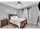 Cozy bedroom with plush carpeting, neutral decor, and a large window at 947 Summer Forest Drive, Suwanee, GA 30024