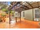 View of the wet, stained deck with a pergola overhead and an outdoor bar-top at 947 Summer Forest Drive, Suwanee, GA 30024