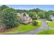 A picturesque view of a two-story home with a well-maintained lawn, complemented by mature trees at 947 Summer Forest Drive, Suwanee, GA 30024