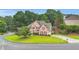 Charming brick front exterior of a two-story home with a manicured lawn and mature trees at 947 Summer Forest Drive, Suwanee, GA 30024