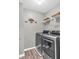 Laundry room with shelving and stainless steel washer and dryer at 947 Summer Forest Drive, Suwanee, GA 30024