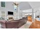 Spacious living room with vaulted ceilings, fireplace, and open floor plan to the kitchen at 947 Summer Forest Drive, Suwanee, GA 30024