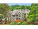 A rear exterior view of a two-story home, showcasing the upper and lower windows with an orange deck at 947 Summer Forest Drive, Suwanee, GA 30024