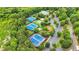 Aerial view of the community tennis courts, playground, parking, and pool surrounded by lush greenery at 947 Summer Forest Drive, Suwanee, GA 30024
