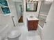 Bright bathroom features a single sink vanity, tiled shower/tub, and neutral tile flooring at 710 Montclair Sw Dr, Smyrna, GA 30082