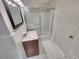 Bathroom featuring shower/tub combo with glass door, updated vanity, and tile flooring at 710 Montclair Sw Dr, Smyrna, GA 30082