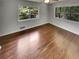This bedroom features hardwood floors, a ceiling fan, and two windows for ample natural light at 710 Montclair Sw Dr, Smyrna, GA 30082