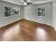 Bright bedroom with hardwood floors, ceiling fan, and two windows overlooking the yard at 710 Montclair Sw Dr, Smyrna, GA 30082