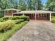 Charming single-story home featuring a brick facade, covered porch, and well-maintained landscaping at 710 Montclair Sw Dr, Smyrna, GA 30082
