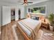 Cozy main bedroom with hardwood floors, neutral tones, ceiling fan, and natural light at 710 Montclair Sw Dr, Smyrna, GA 30082