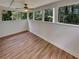 Relaxing sun room with hardwood floors and large windows overlooking the wooded backyard at 710 Montclair Sw Dr, Smyrna, GA 30082