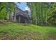 Expansive backyard featuring a deck, stairs, and lush green landscape, surrounded by tall trees at 747 Mill Rock St, Lawrenceville, GA 30044