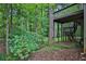 Backyard view showing the deck and stairs leading down to the wooded area at 747 Mill Rock St, Lawrenceville, GA 30044