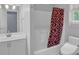 Bathroom with a modern toilet, white vanity, and a shower featuring a patterned curtain at 747 Mill Rock St, Lawrenceville, GA 30044