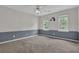Spacious bedroom featuring neutral paint, two windows offering natural light, and a ceiling fan at 747 Mill Rock St, Lawrenceville, GA 30044