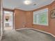 Bedroom showcasing neutral colored walls, carpet, a window with wood trim, and adjoining bathroom at 747 Mill Rock St, Lawrenceville, GA 30044