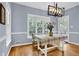 Dining area with hardwood floors, stylish chandelier, and door to outside at 747 Mill Rock St, Lawrenceville, GA 30044