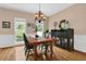 Classic dining room with hardwood floors, traditional decor, and ample natural light at 747 Mill Rock St, Lawrenceville, GA 30044