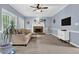 Inviting living room with cozy fireplace, plush sofa, and natural light from bright windows at 747 Mill Rock St, Lawrenceville, GA 30044
