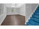 Bright living room with tray ceilings, wood-look floors, and a staircase leading to an upper level at 747 Mill Rock St, Lawrenceville, GA 30044