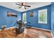 Office space with wood floors, blue walls, large windows, and a ceiling fan at 747 Mill Rock St, Lawrenceville, GA 30044