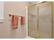 Bathroom shower with glass door, gold trim, and a towel rack at 747 Mill Rock St, Lawrenceville, GA 30044