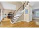 Modern staircase with wood treads, white risers, and cable railing, leading to the upper level of the home at 747 Mill Rock St, Lawrenceville, GA 30044
