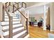 Elegant staircase with wood and white finishes leading to a spacious living area at 747 Mill Rock St, Lawrenceville, GA 30044