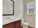 Half bathroom featuring a dark wood vanity, a white countertop, and a framed mirror at 1300 Hopkins Dr, Decatur, GA 30033